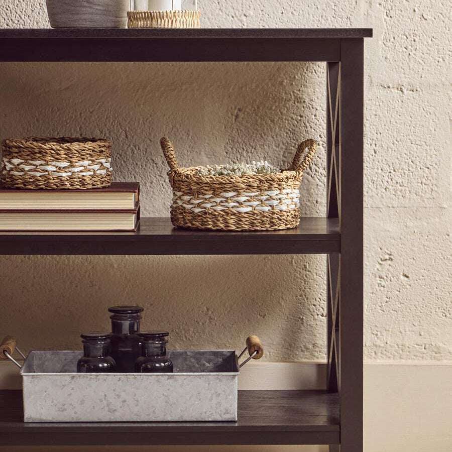 Dark wood console table with woven baskets and candle holder for home storage