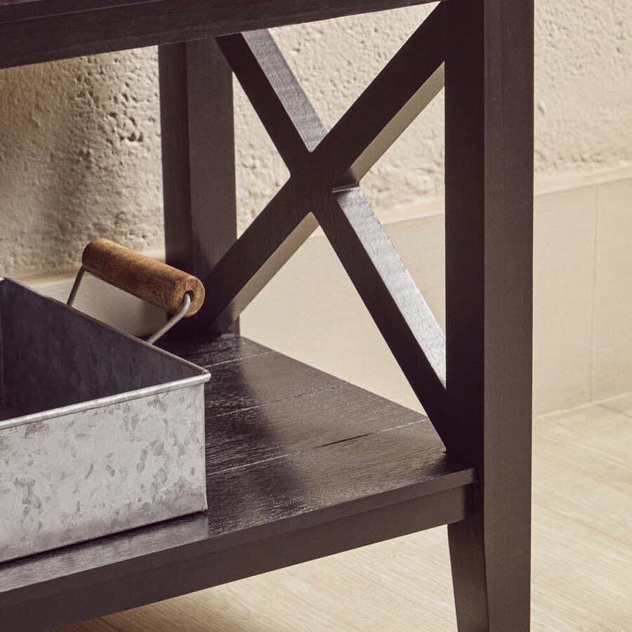 Black wooden console table with cross-leg design and lower shelf in modern interior