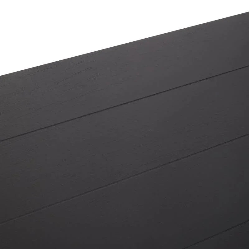 Close-up of black wood dining table surface with subtle grain and lined texture