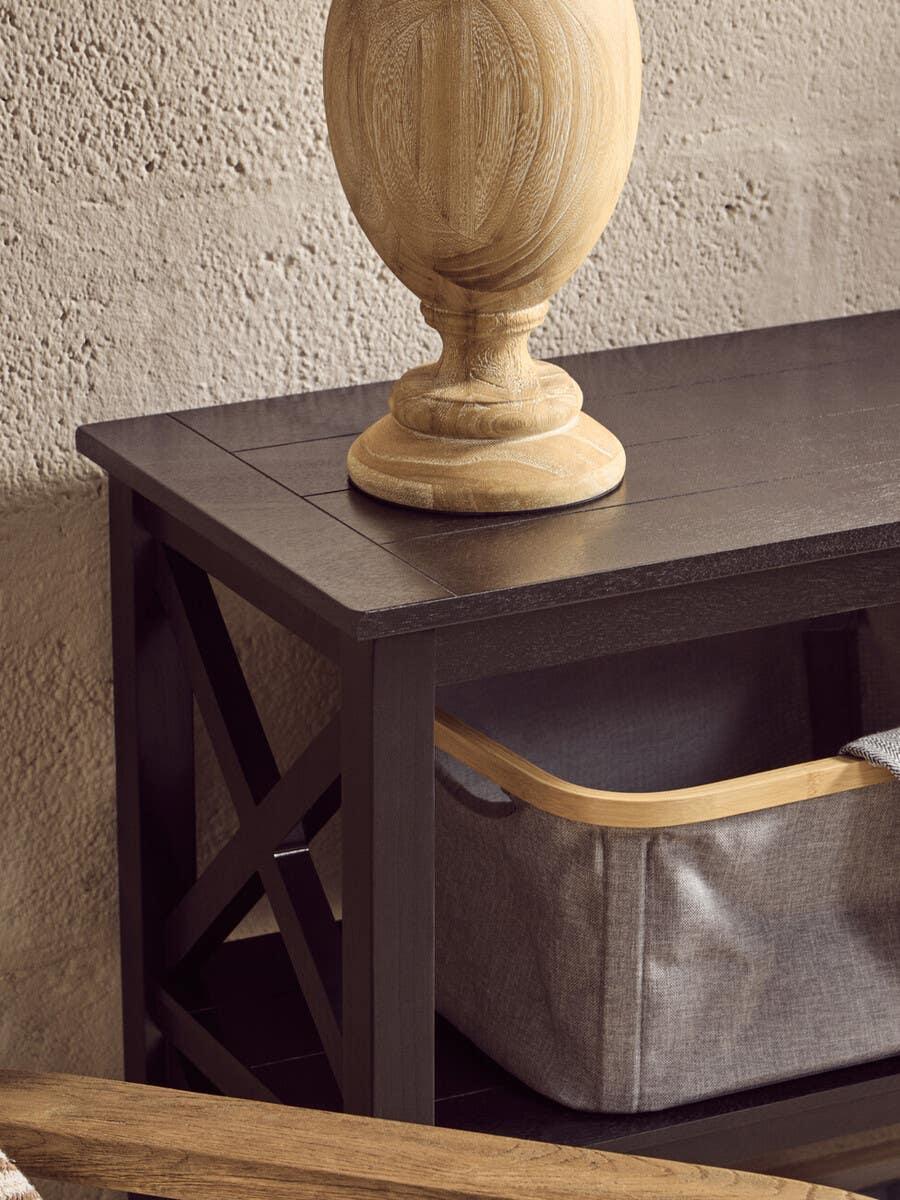 Dark wood console table with cross side detail and fabric storage basket underneath