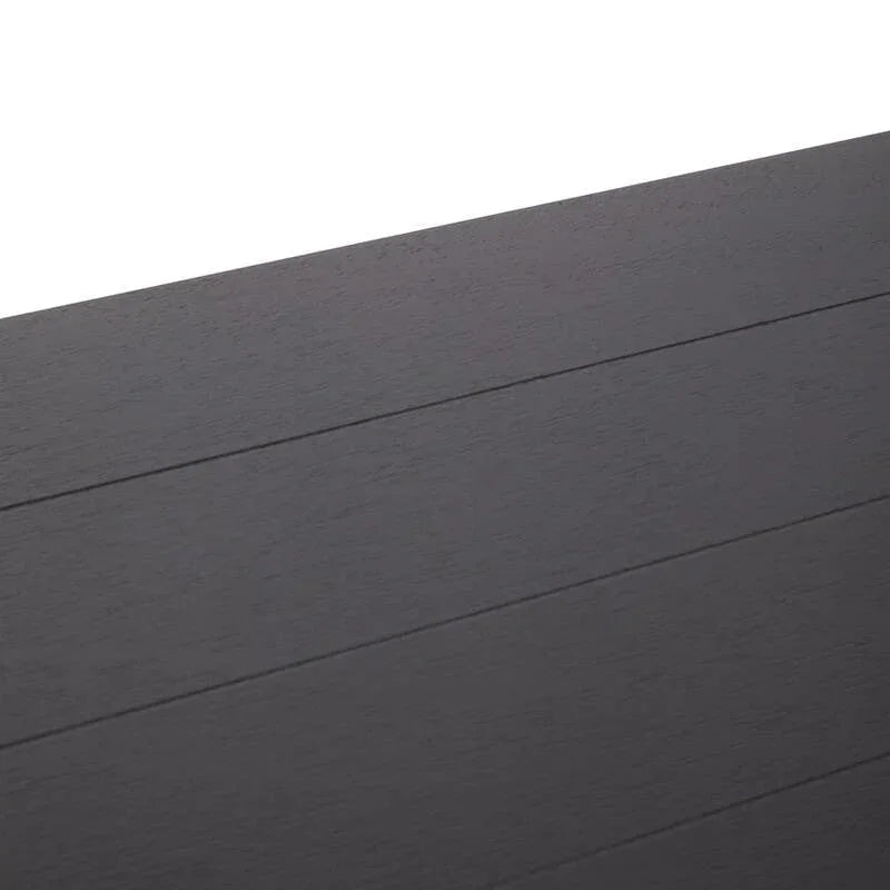 Close view of black wood dining table top with visible grain and panel lines