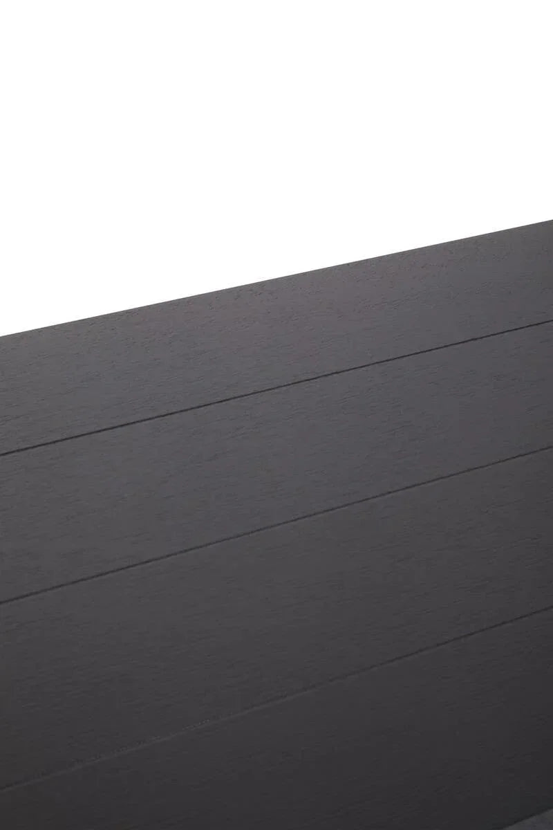 Close view of black wood dining table top with visible grain and panel lines