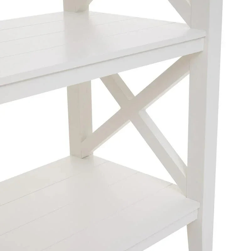 White wooden shelving unit with cross detail and slatted shelves, close side view