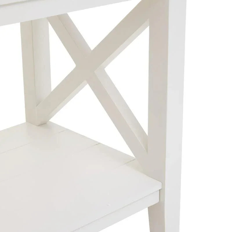 White wooden shelving unit with cross side detail and smooth finish, close-up view