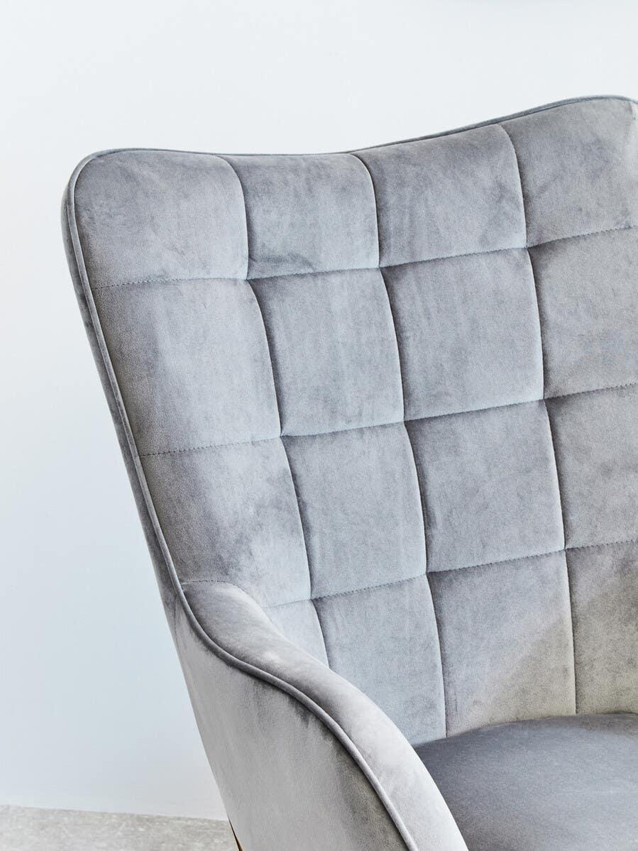 Grey velvet accent chair with square stitched backrest close-up