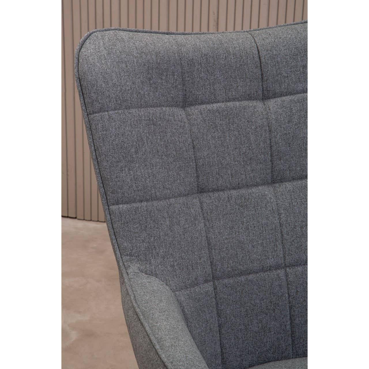 Close-up of grey fabric armchair with square stitched panel backrest