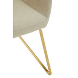 Beige fabric chair seat with gold metal leg, close-up on upholstery and frame detail