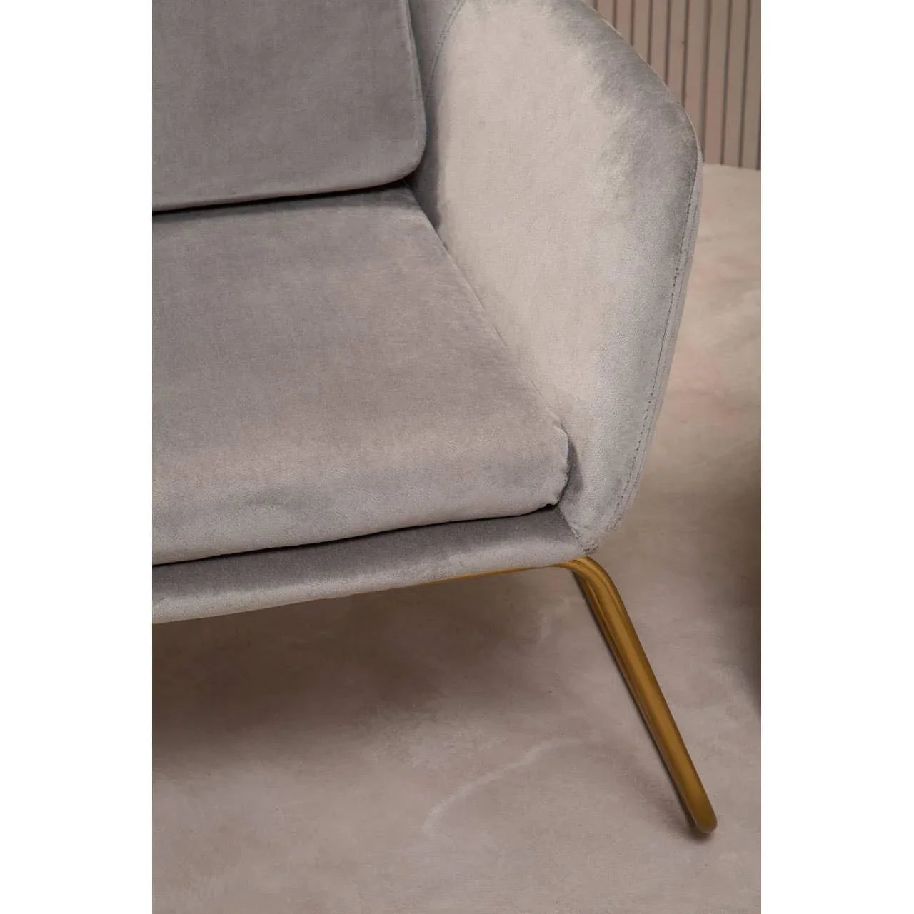 Grey velvet sofa corner with gold metal leg on beige floor