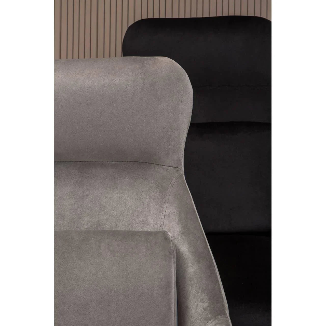 Closeup of grey velvet and black velvet chair backs with modern panelled background