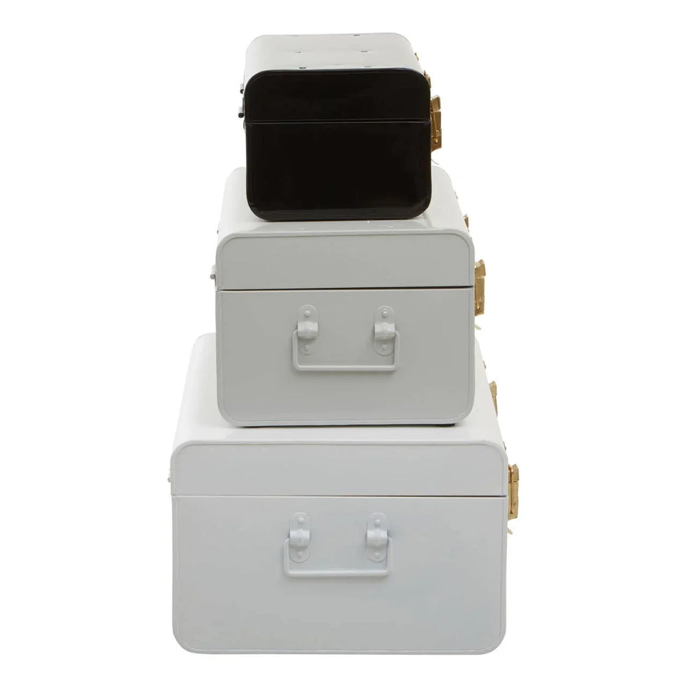 Set of three metal storage trunks in white and black with gold latches, stacked vertically