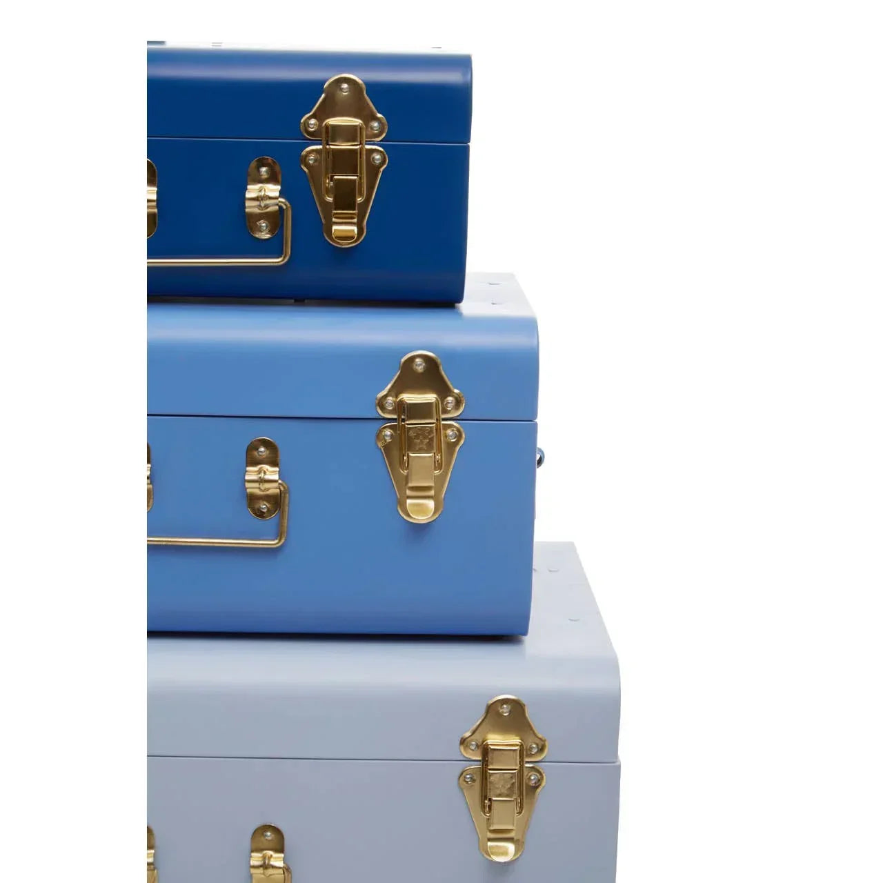 Stacked storage trunks in gradient blue shades with gold metal latches and handles