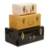Set of three metal storage trunks in cream, mustard, and black with gold clasps and handles