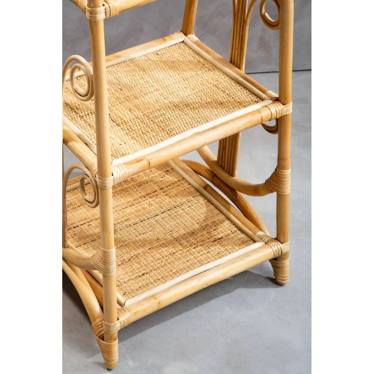 Natural rattan shelving unit with woven shelves and decorative curved supports