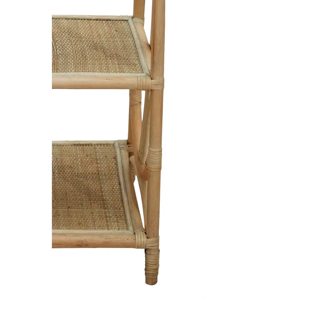 Close-up of natural rattan shelving unit with woven shelves and bamboo frame