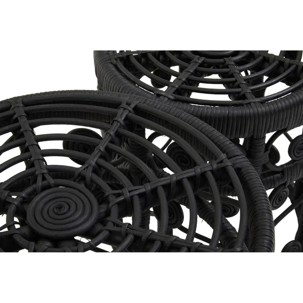 Black rattan side table top detail with circular woven pattern and textured finish