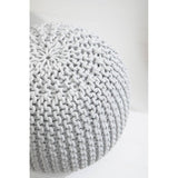 A round grey knit pouffe with a textured surface, featuring a pattern of interwoven yarn that creates a cozy and inviting look, placed against a light-colored background
