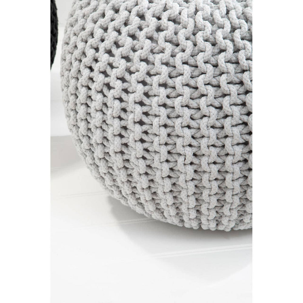 Round grey knit pouffe with a textured pattern, resting on a light surface. The pouffe features a soft, cozy appearance, suitable for children's rooms or play areas