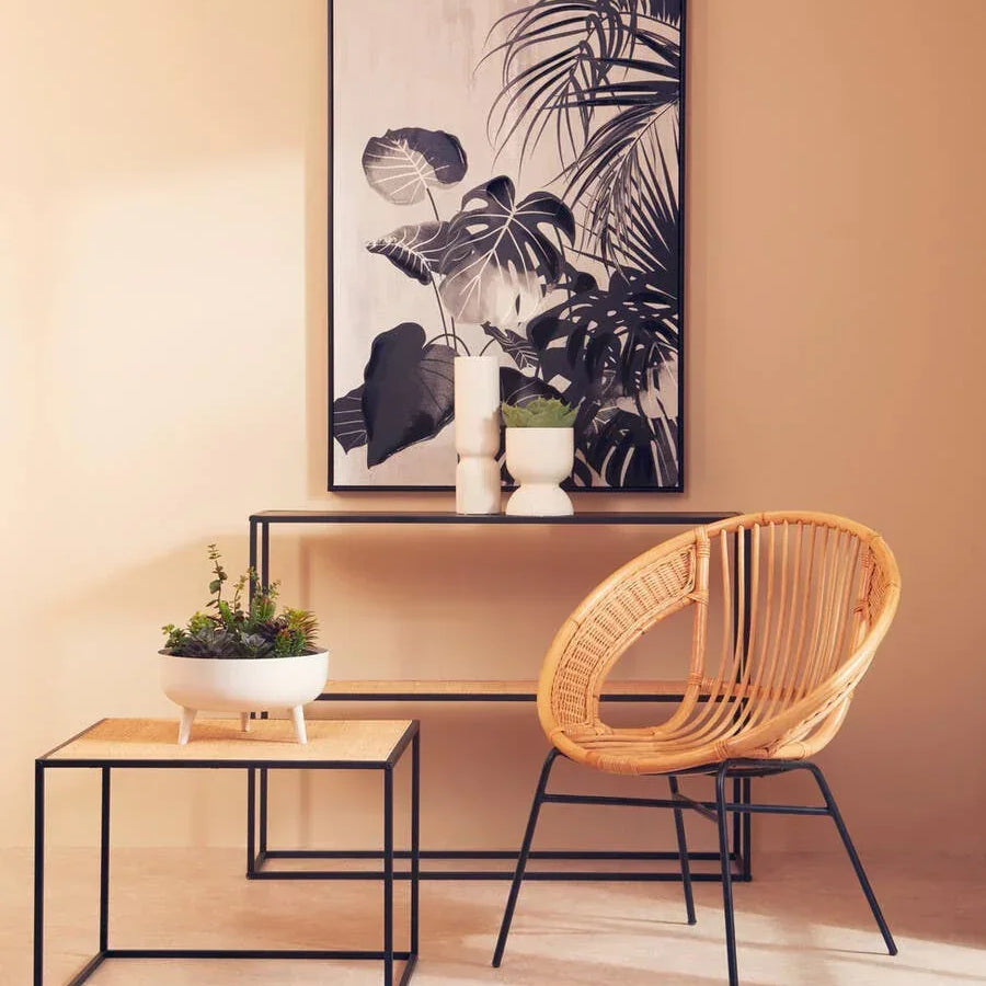 Rattan accent chair and side table with metal frame in modern living room setting