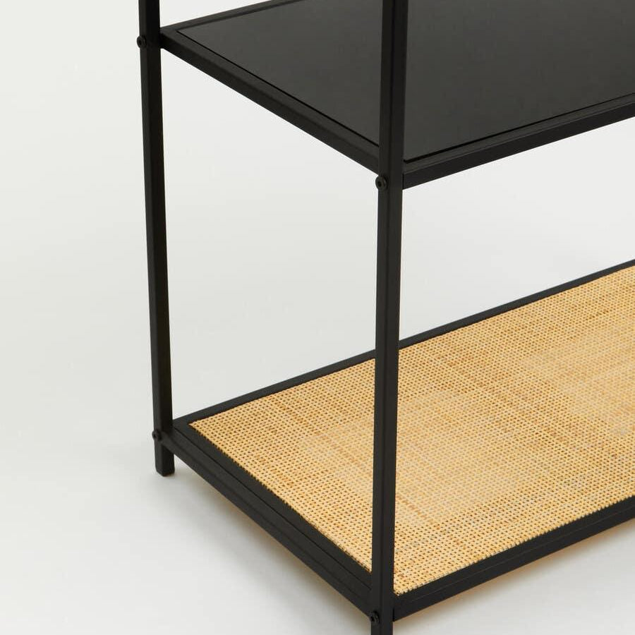 Black metal shelving unit with glass and woven rattan shelf detail