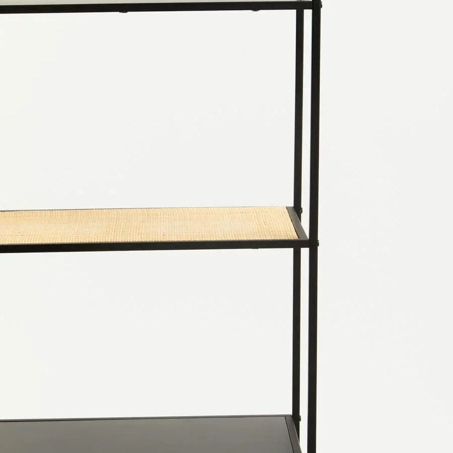 Black metal shelving unit with one natural rattan shelf and minimalist design