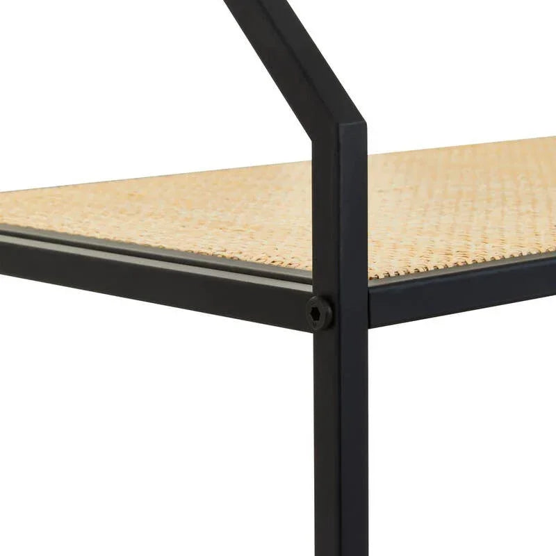 Close up of black metal furniture frame with woven rattan shelf surface
