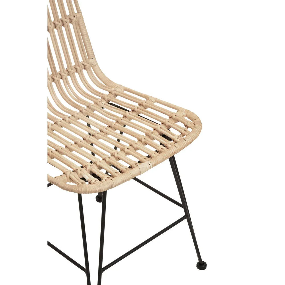 Natural rattan dining chair with black metal legs, close-up of seat and frame detail