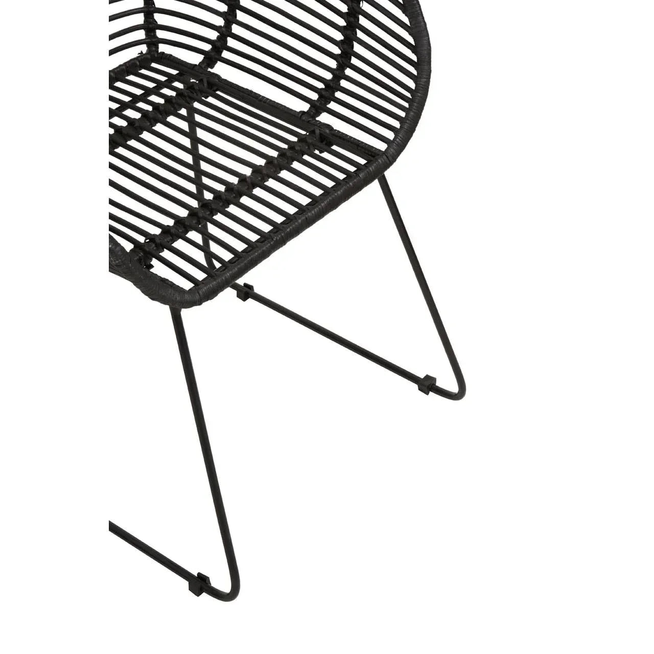 Black rattan chair seat and metal legs, close-up of modern dining furniture design
