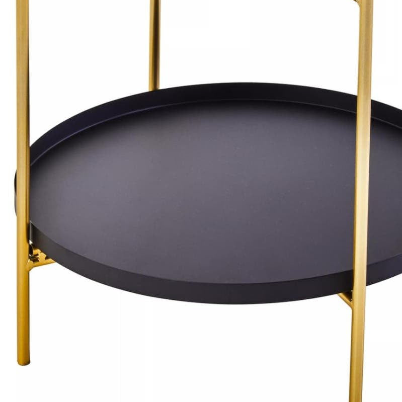 Two-tier side table featuring a sleek black circular top and bottom shelf, supported by elegant gold metal legs. The design is modern and minimalist, suitable for various home decor styles