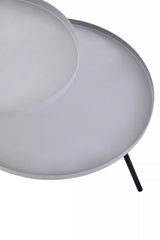 A modern side table featuring two circular shelves, one in a light grey finish and the other in a contrasting black. The table has slender black legs that provide stability and a sleek look, suitable for contemporary home decor