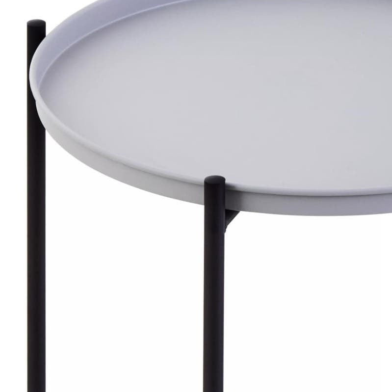 Round grey tabletop supported by slender black legs, featuring a minimalist design suitable for modern home decor