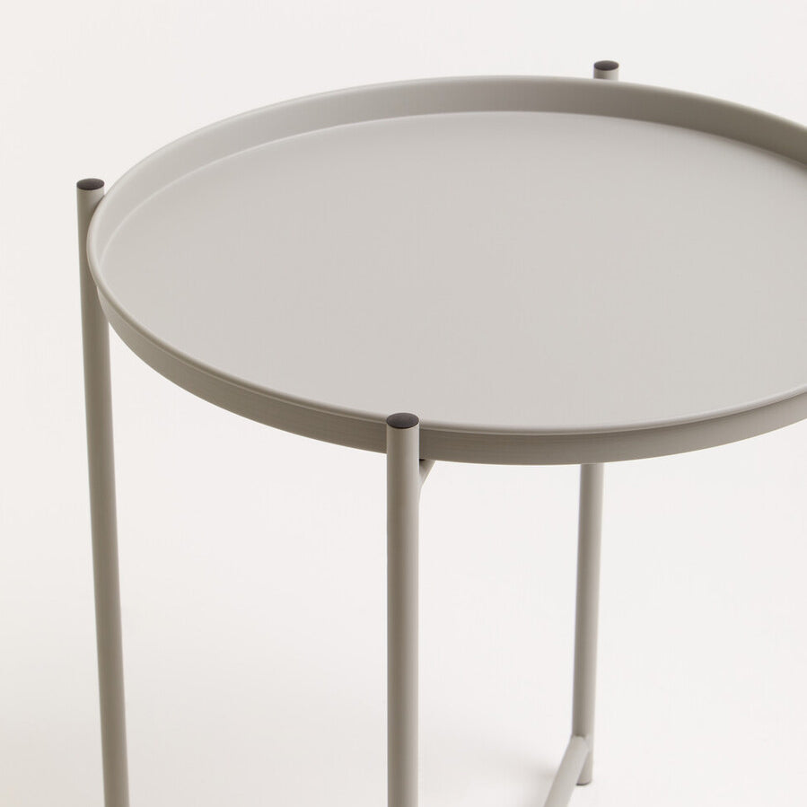 Round grey iron side table with a smooth top and slender legs, featuring a minimalist design suitable for modern home decor