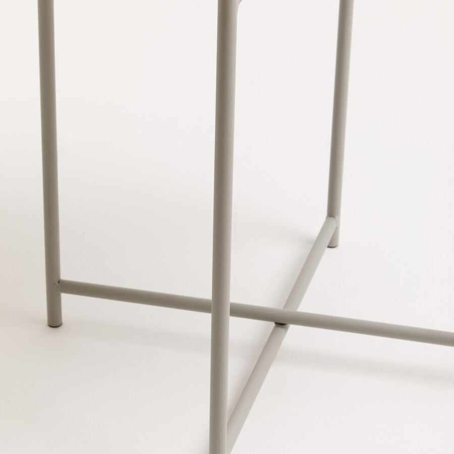 Grey iron side table featuring a round top and slender legs with a crossbar for stability, set against a neutral background