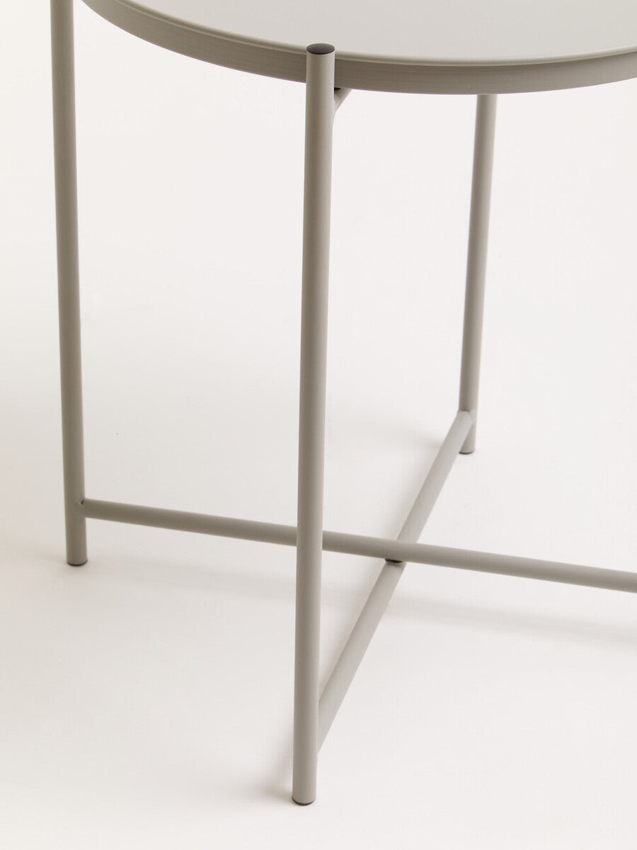 Grey iron side table featuring a round top and slender legs with a crossbar for stability, set against a neutral background