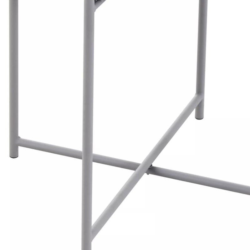 Round grey tabletop supported by a sleek, minimalist iron frame with a crossbar for stability. The design features clean lines and a modern aesthetic, suitable for various home decor styles