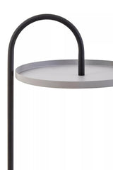 A modern side table featuring a circular grey tabletop with a sleek black metal frame. The frame has a curved handle design that arches over the tabletop, creating a minimalist and stylish look suitable for contemporary home decor
