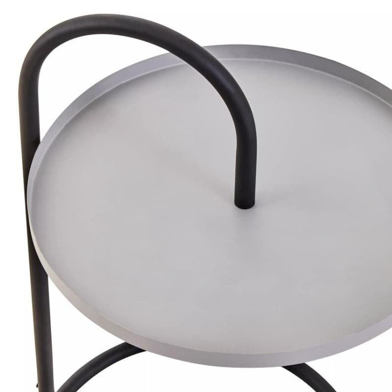 A modern side table featuring a round grey top with a smooth surface, supported by a sleek black metal frame. The table has a unique hanging design with a curved handle on one side, adding a contemporary touch to its overall aesthetic