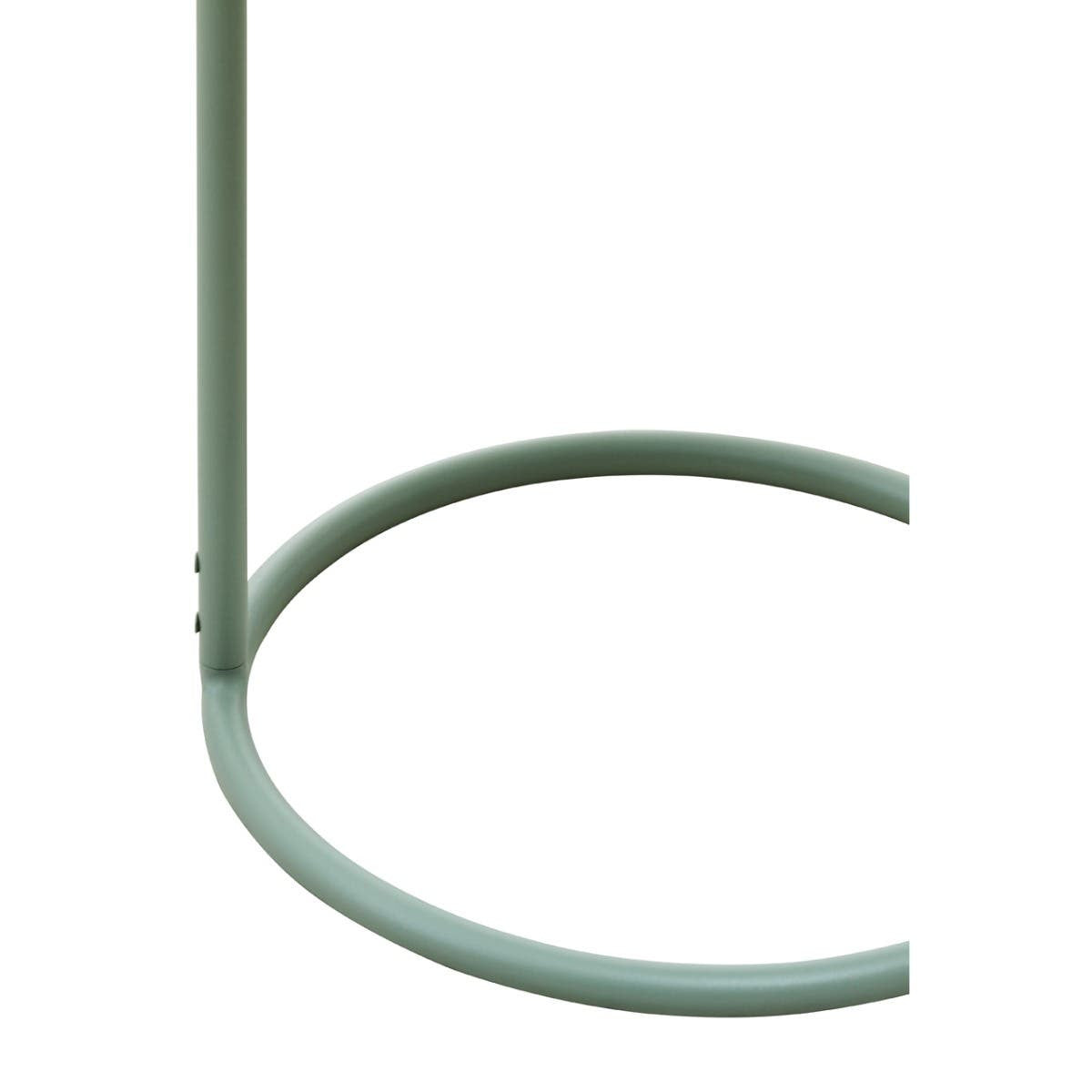 Green metal side table with a circular base and a slender vertical support, designed to hang from a surface. The table features a minimalist style, showcasing a smooth finish and a modern aesthetic