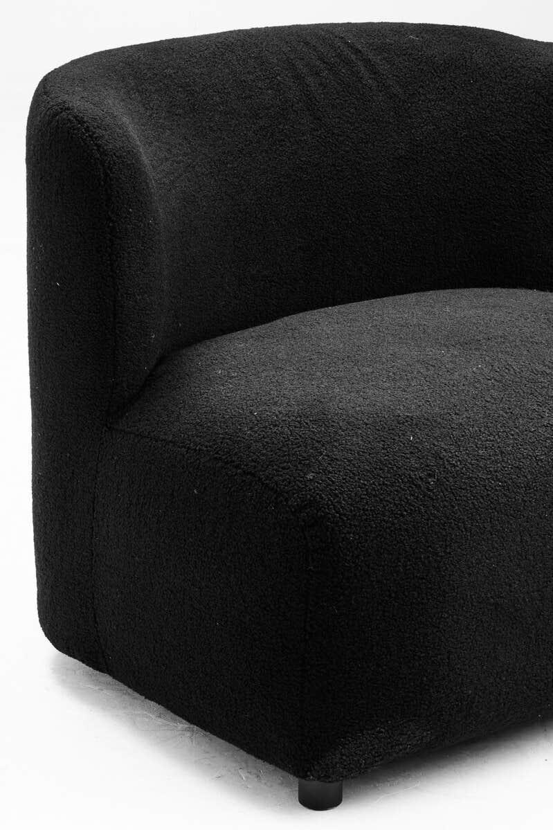 Curved black fabric armchair with textured upholstery and low round leg