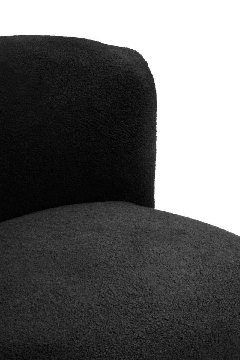 Close-up of black boucle fabric accent chair backrest and seat