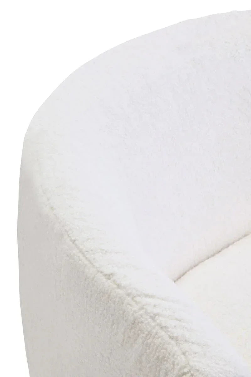 Close-up of white boucle armchair with curved backrest upholstery