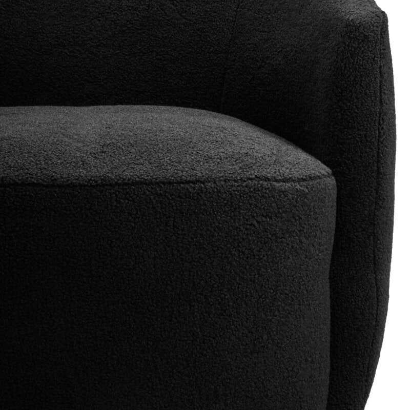 Curved black boucle accent chair with rounded backrest and plush upholstery, close up view