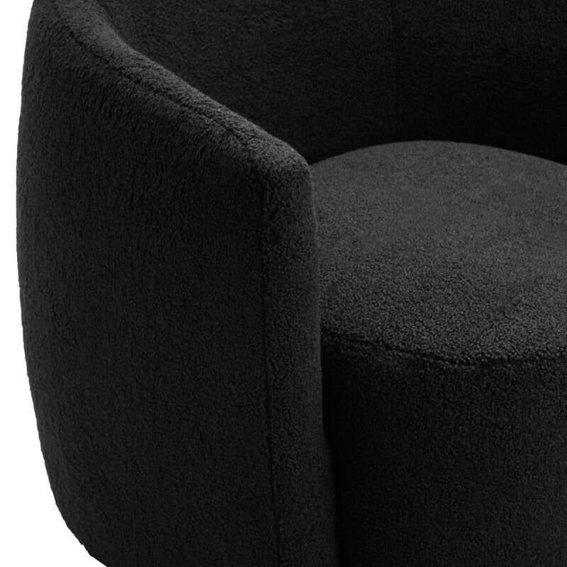 Black boucle accent chair with curved backrest and minimalist design