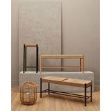 Woven jute bench and stool set with black and natural wood frames on textured rug