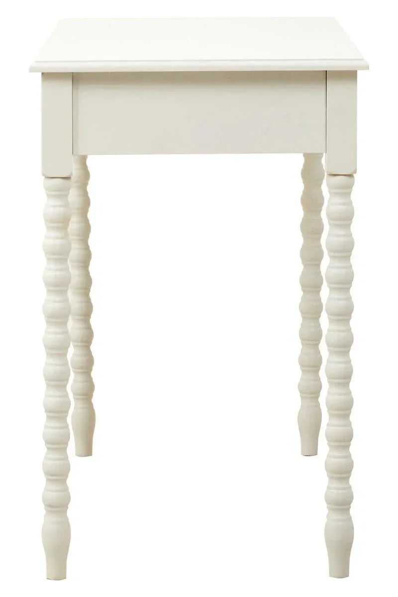 White wooden side table with carved spindle legs, front angle view