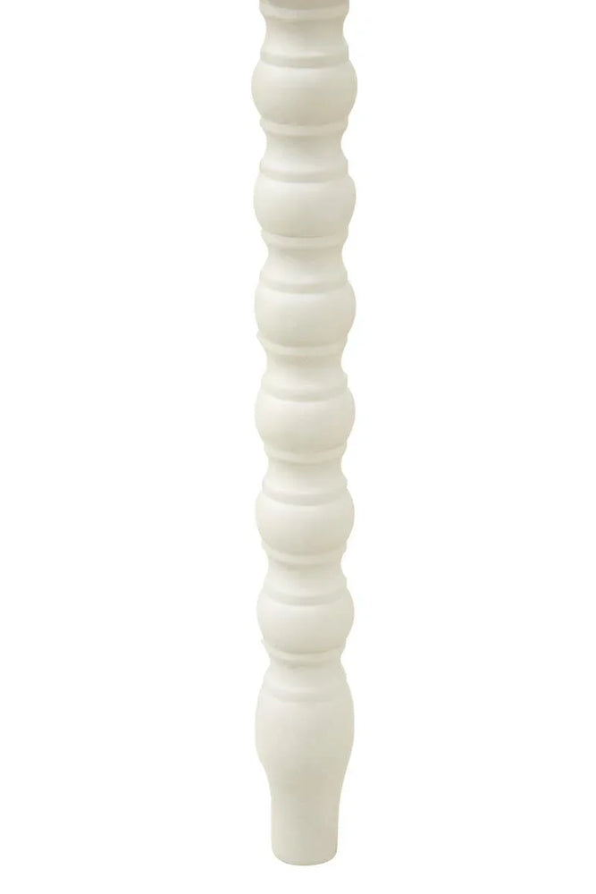 White wooden furniture leg with turned spindle design, close-up view