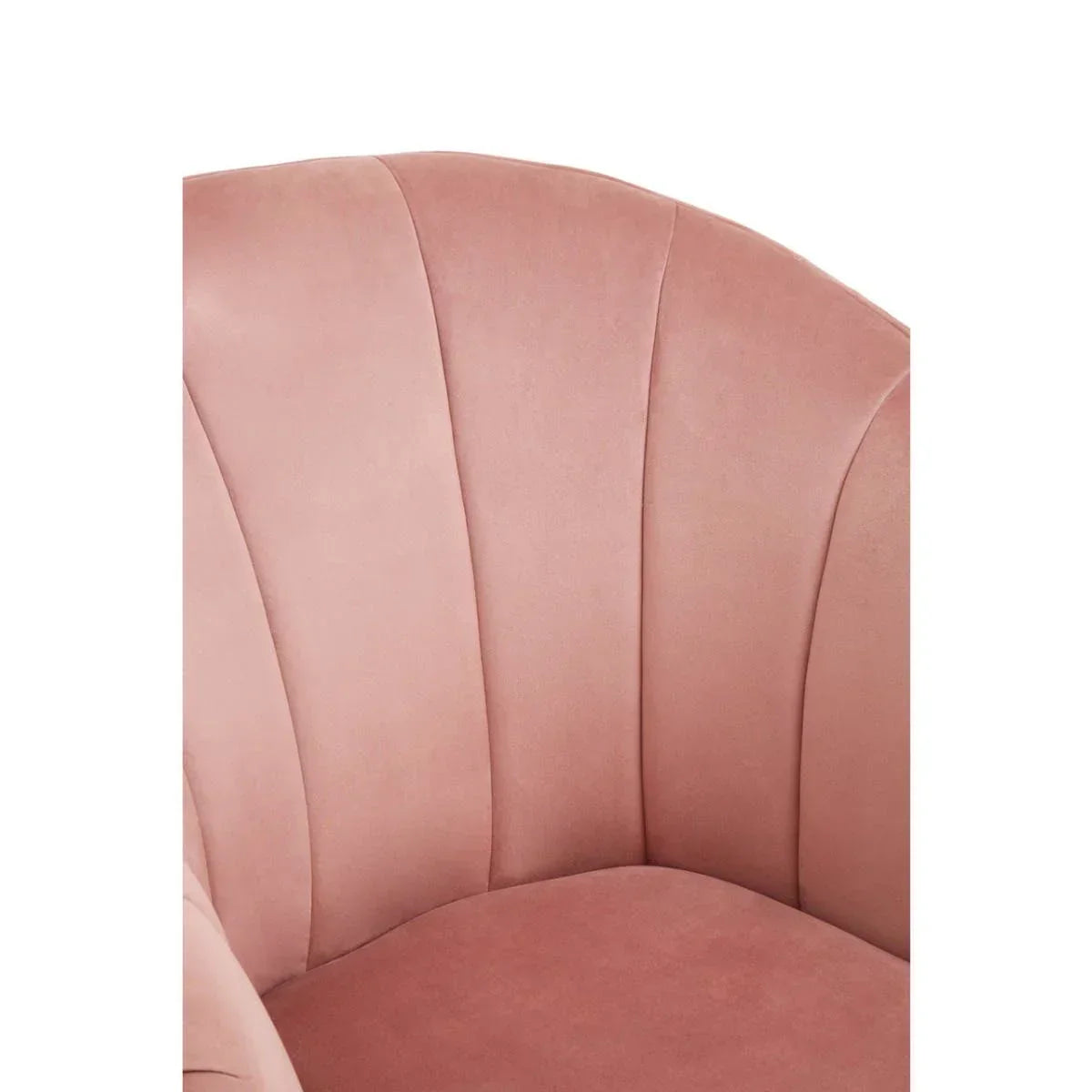 Close view of pink velvet armchair with scalloped backrest and plush seat cushion