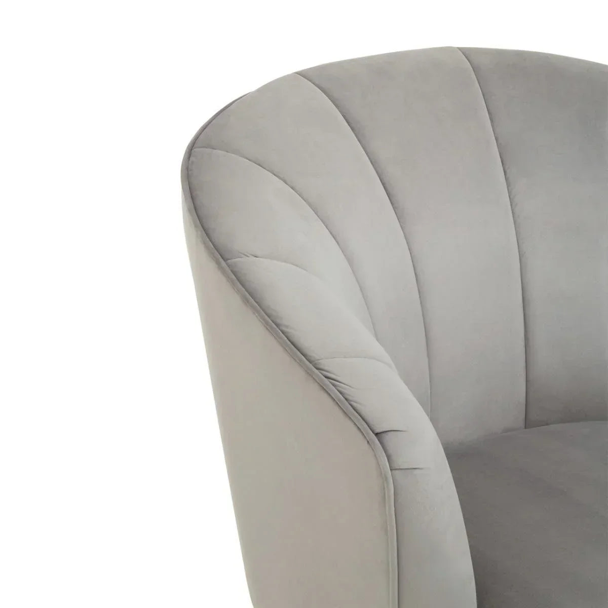 Light grey velvet armchair with fluted backrest, close-up of curved arm and upholstery