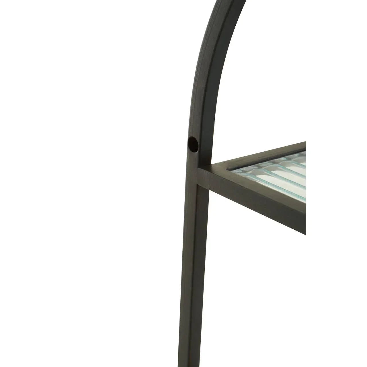Close-up of metal furniture frame with glass shelf detail