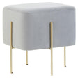 Square stool upholstered in soft grey velvet with four slender gold legs, featuring a minimalist design suitable for modern home decor