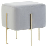 Square stool upholstered in soft grey velvet with four slender gold legs, featuring a minimalist design suitable for modern home decor